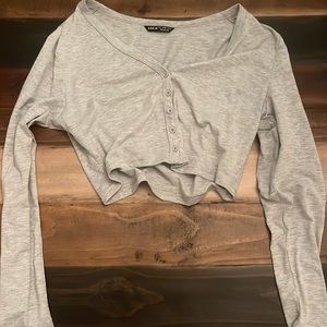 Long sleeve grey button down top.